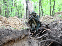 Soldiers are practicing clearing a trench from the enemy in pairs during the drills of the Liut (Fury) Brigade of the National Police of Ukr...