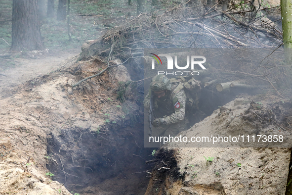 Soldiers are practicing clearing a trench from the enemy in pairs during the drills of the Liut (Fury) Brigade of the National Police of Ukr...