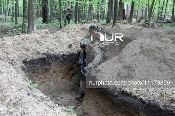 Soldiers are practicing clearing a trench from the enemy in pairs during the drills of the Liut (Fury) Brigade of the National Police of Ukr...