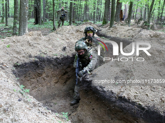 Soldiers are practicing clearing a trench from the enemy in pairs during the drills of the Liut (Fury) Brigade of the National Police of Ukr...