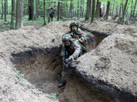 Soldiers are practicing clearing a trench from the enemy in pairs during the drills of the Liut (Fury) Brigade of the National Police of Ukr...