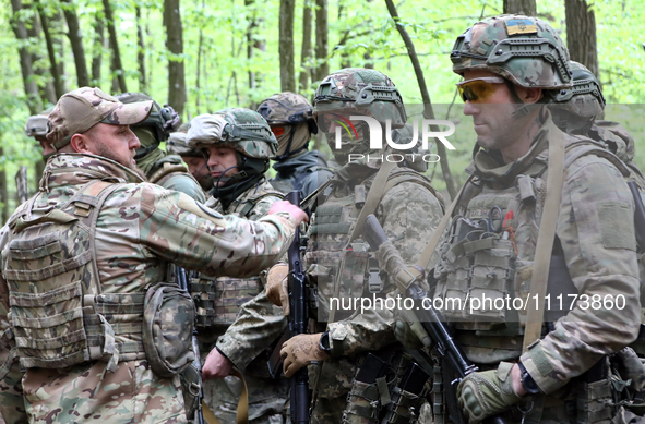 Soldiers are receiving instructions before the start of the drills of the Liut (Fury) Brigade of the National Police of Ukraine at a trainin...