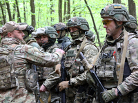 Soldiers are receiving instructions before the start of the drills of the Liut (Fury) Brigade of the National Police of Ukraine at a trainin...