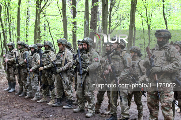 Soldiers are receiving instructions before the start of the drills of the Liut (Fury) Brigade of the National Police of Ukraine at a trainin...