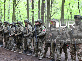 Soldiers are receiving instructions before the start of the drills of the Liut (Fury) Brigade of the National Police of Ukraine at a trainin...