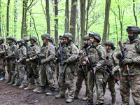 Soldiers are receiving instructions before the start of the drills of the Liut (Fury) Brigade of the National Police of Ukraine at a trainin...