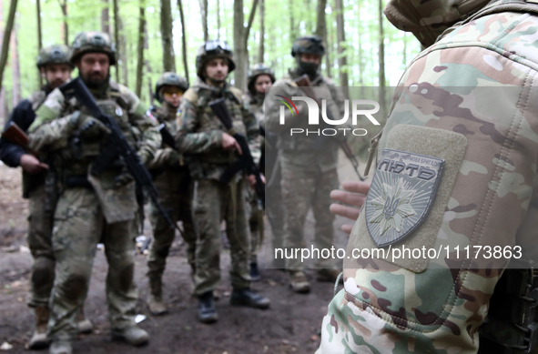 A shoulder sleeve insignia of the Liut (Fury) Brigade of the National Police of Ukraine is being pictured during drills at a training area i...