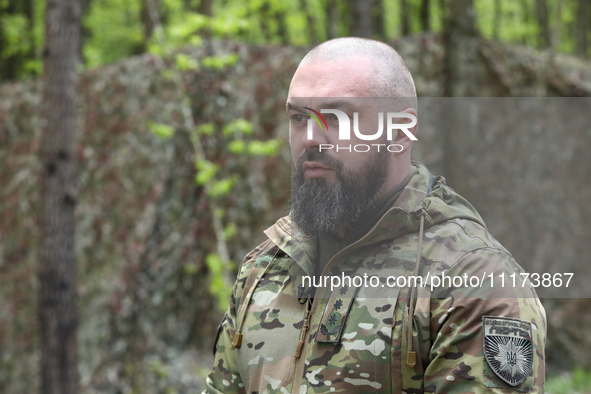 Commander of the Liut (Fury) Brigade of the National Police of Ukraine, Andrii Matviienko, is speaking to the press during drills at a train...