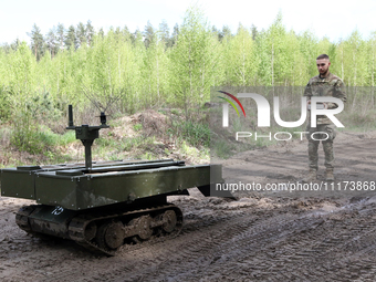 A serviceman is standing before the VEPR ground logistics robotic complex during drills of the Liut (Fury) Brigade of the National Police of...