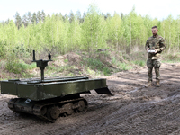 A serviceman is standing before the VEPR ground logistics robotic complex during drills of the Liut (Fury) Brigade of the National Police of...