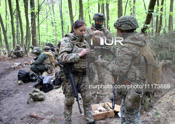 Soldiers are getting ready for the start of the drills of the Liut (Fury) Brigade of the National Police of Ukraine at a training area in th...