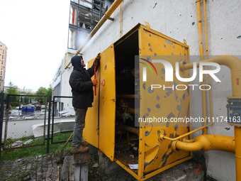 A man is repairing equipment in the Shevchenkivskyi district after a Russian missile attack in Kharkiv, Ukraine, on April 24, 2024. (