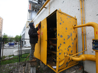 A man is repairing equipment in the Shevchenkivskyi district after a Russian missile attack in Kharkiv, Ukraine, on April 24, 2024. (