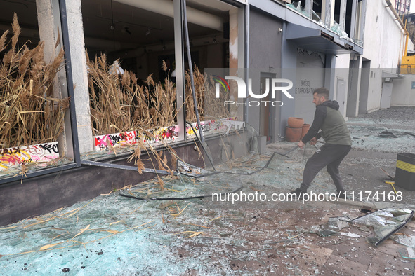 A man is removing broken glass in the Shevchenkivskyi district after a Russian missile attack in Kharkiv, Ukraine, on April 24, 2024. 