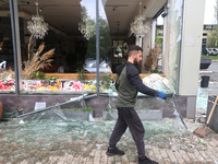 A man is removing broken glass in the Shevchenkivskyi district after a Russian missile attack in Kharkiv, Ukraine, on April 24, 2024. (