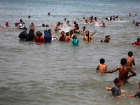 Palestinians are enjoying the beach on a hot day, amid the ongoing conflict between Israel and Hamas, in Deir Al-Balah, in the central Gaza...