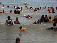 Palestinians are enjoying the beach on a hot day, amid the ongoing conflict between Israel and Hamas, in Deir Al-Balah, in the central Gaza...