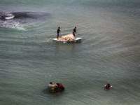 Palestinian fishermen are working in the sea amid the ongoing conflict between Israel and Hamas in Deir Al-Balah, in the central Gaza Strip,...