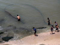 Palestinian fishermen are working in the sea amid the ongoing conflict between Israel and Hamas in Deir Al-Balah, in the central Gaza Strip,...