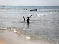 Palestinian fishermen are working in the sea amid the ongoing conflict between Israel and Hamas in Deir Al-Balah, in the central Gaza Strip,...