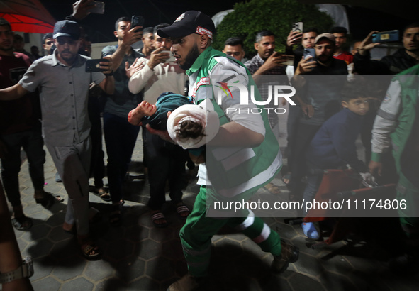 Palestinians are transporting an injured person to the Al-Aqsa Martyrs Hospital in Deir Balah in the central Gaza Strip, on April 24, 2024,...