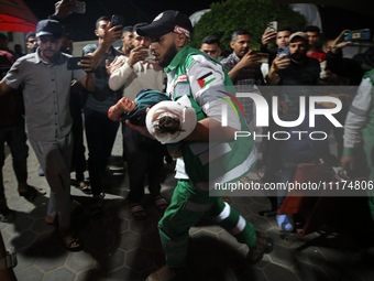 Palestinians are transporting an injured person to the Al-Aqsa Martyrs Hospital in Deir Balah in the central Gaza Strip, on April 24, 2024,...