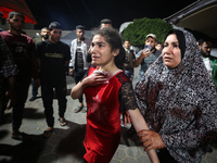 Palestinians are transporting an injured person to the Al-Aqsa Martyrs Hospital in Deir Balah in the central Gaza Strip, on April 24, 2024,...