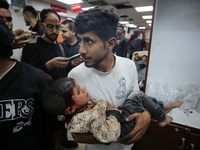 Palestinians are transporting an injured person to the Al-Aqsa Martyrs Hospital in Deir Balah in the central Gaza Strip, on April 24, 2024,...