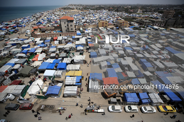 Palestinians are taking shelter in a tent camp in Deir Balah in the central Gaza Strip on April 24, 2024, after fleeing their homes due to I...