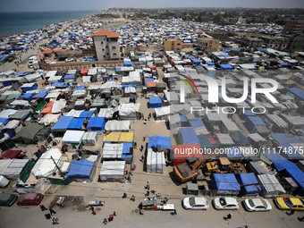 Palestinians are taking shelter in a tent camp in Deir Balah in the central Gaza Strip on April 24, 2024, after fleeing their homes due to I...