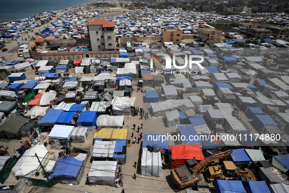 Palestinians are taking shelter in a tent camp in Deir Balah in the central Gaza Strip on April 24, 2024, after fleeing their homes due to I...