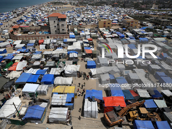 Palestinians are taking shelter in a tent camp in Deir Balah in the central Gaza Strip on April 24, 2024, after fleeing their homes due to I...