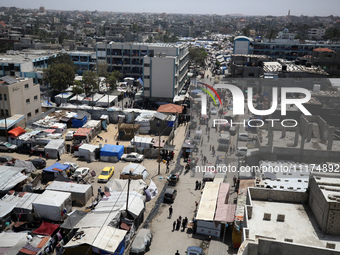 Palestinians are taking shelter in a tent camp in Deir Balah in the central Gaza Strip on April 24, 2024, after fleeing their homes due to I...