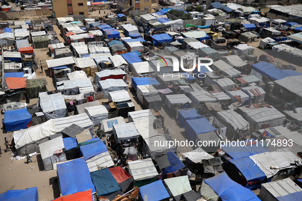 Palestinians are taking shelter in a tent camp in Deir Balah in the central Gaza Strip on April 24, 2024, after fleeing their homes due to I...