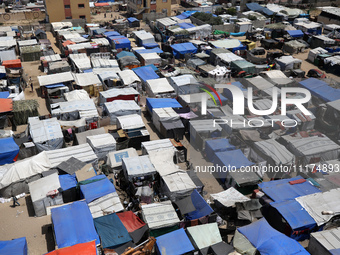 Palestinians are taking shelter in a tent camp in Deir Balah in the central Gaza Strip on April 24, 2024, after fleeing their homes due to I...