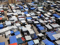 Palestinians are taking shelter in a tent camp in Deir Balah in the central Gaza Strip on April 24, 2024, after fleeing their homes due to I...