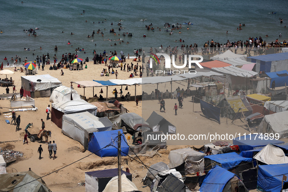 Palestinians are taking shelter in a tent camp in Deir Balah in the central Gaza Strip on April 24, 2024, after fleeing their homes due to I...