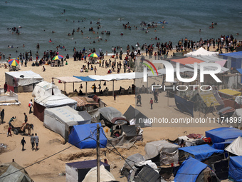 Palestinians are taking shelter in a tent camp in Deir Balah in the central Gaza Strip on April 24, 2024, after fleeing their homes due to I...