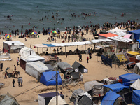 Palestinians are taking shelter in a tent camp in Deir Balah in the central Gaza Strip on April 24, 2024, after fleeing their homes due to I...