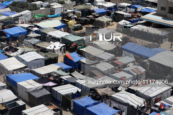 Palestinians are taking shelter in a tent camp in Deir Balah in the central Gaza Strip on April 24, 2024, after fleeing their homes due to I...