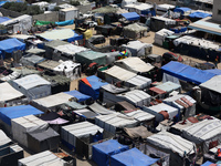 Palestinians are taking shelter in a tent camp in Deir Balah in the central Gaza Strip on April 24, 2024, after fleeing their homes due to I...