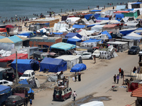 Palestinians are taking shelter in a tent camp in Deir Balah in the central Gaza Strip on April 24, 2024, after fleeing their homes due to I...