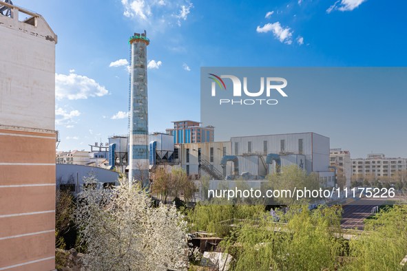 An aerial photo is showing the demolition of a chimney at the Thermal Company in Jiuquan, Gansu Province, China, on April 20, 2024. 