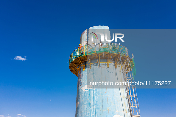 An aerial photo is showing the demolition of a chimney at the Thermal Company in Jiuquan, Gansu Province, China, on April 20, 2024. 