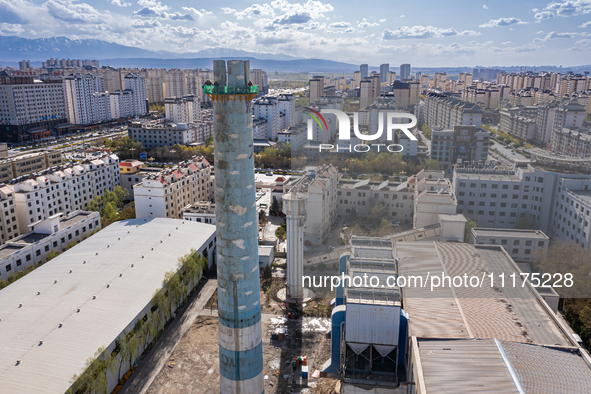 An aerial photo is showing the demolition of a chimney at the Thermal Company in Jiuquan, Gansu Province, China, on April 20, 2024. 