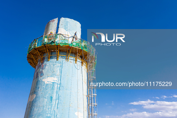 An aerial photo is showing the demolition of a chimney at the Thermal Company in Jiuquan, Gansu Province, China, on April 20, 2024. 