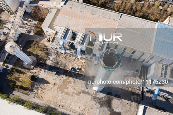 An aerial photo is showing the demolition of a chimney at the Thermal Company in Jiuquan, Gansu Province, China, on April 20, 2024. 