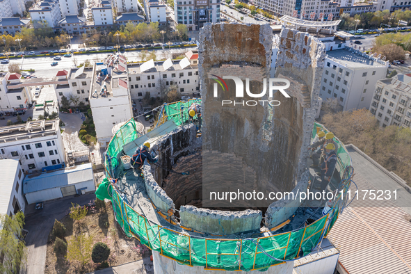 An aerial photo is showing the demolition of a chimney at the Thermal Company in Jiuquan, Gansu Province, China, on April 20, 2024. 