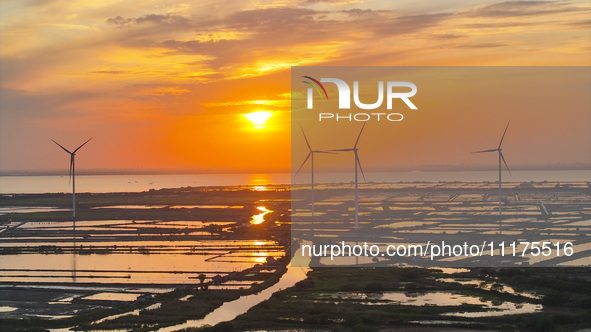 A wind farm is being seen at sunset in Wuxi, China, on April 24, 2024. 