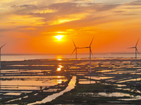 A wind farm is being seen at sunset in Wuxi, China, on April 24, 2024. (